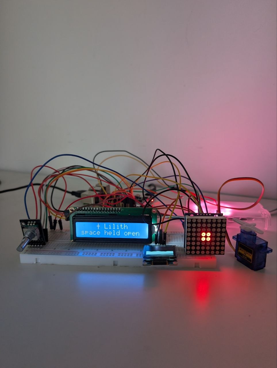 Wide photo of the sensory bridge desk setup with the display, breadboard, and LEDs